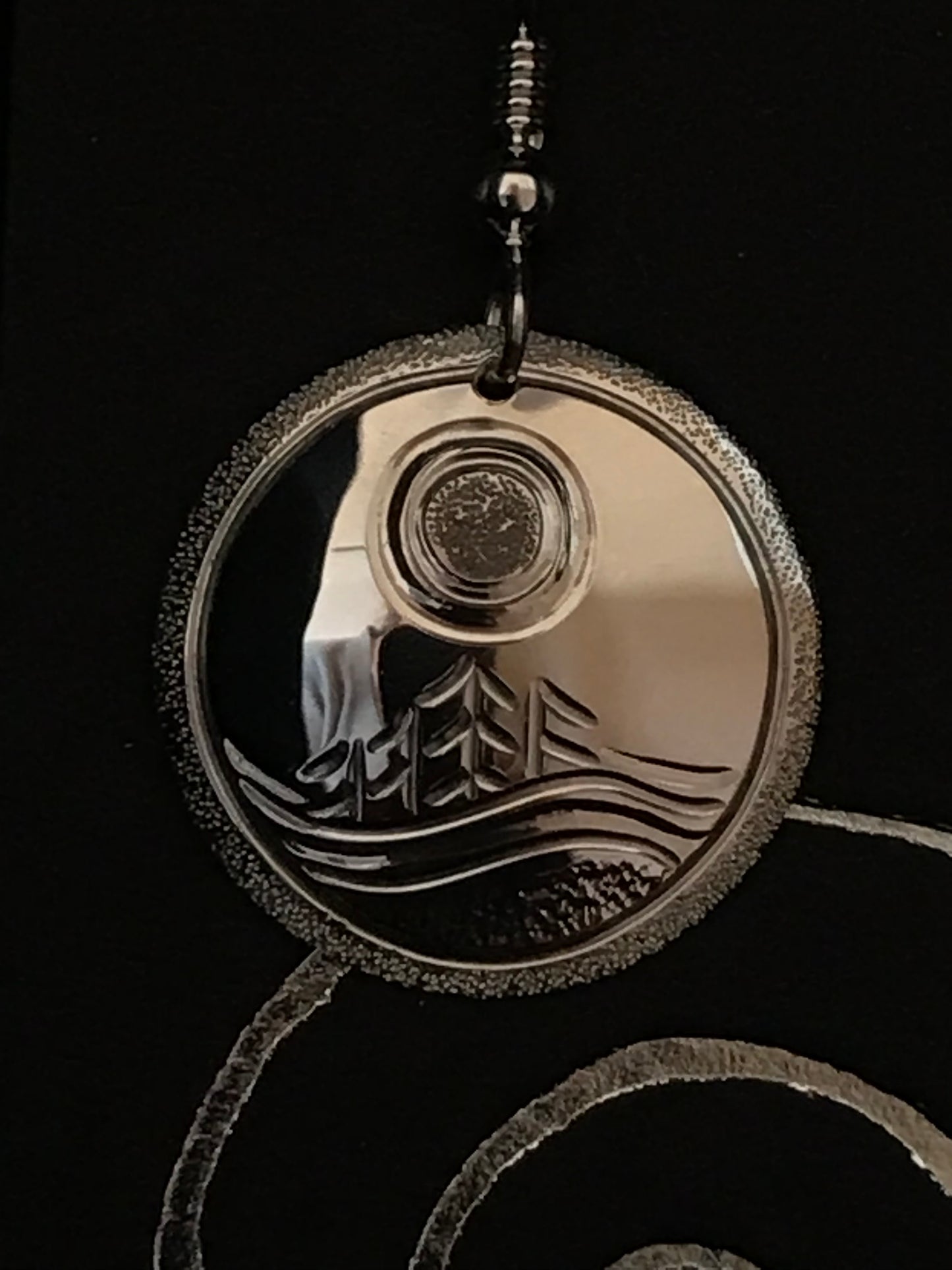 close up of single island earring by Laura Dutheil.