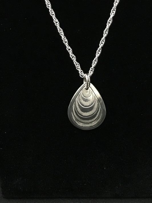 Butter Clam sterling silver drop pendant on ss rope chain by Laura Dutheil.
