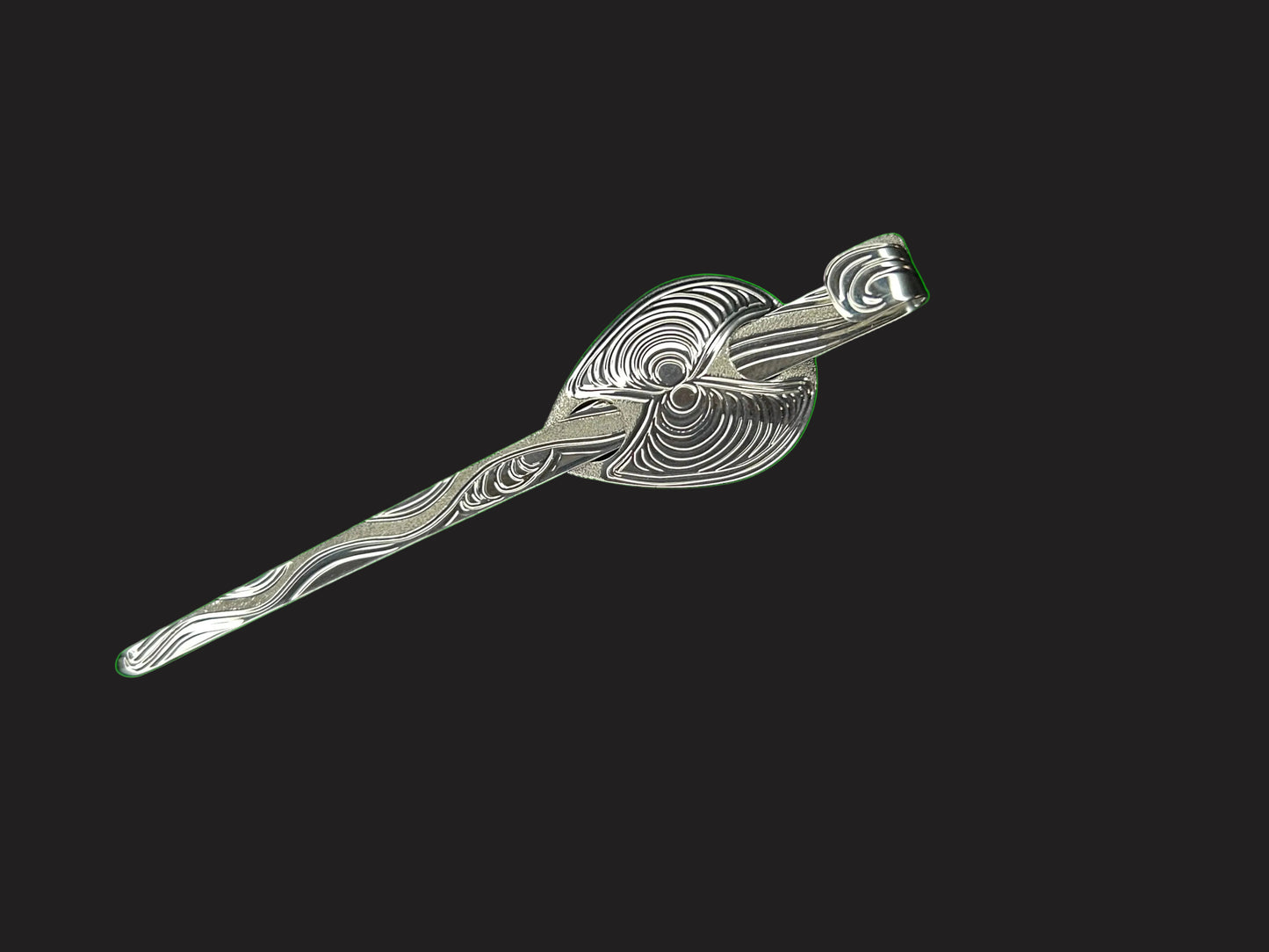 A lovely piece of sterling silver!  Hair jewellery designed and engraved by Laura Dutheil. The Butter Clam with sand dunes , inspired by nature on Haida Gwaii beaches.