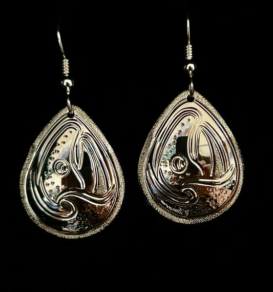 Salmon and waves sterling silver large drop earring designed and engraved by island artisan jeweller Laura Dutheil.