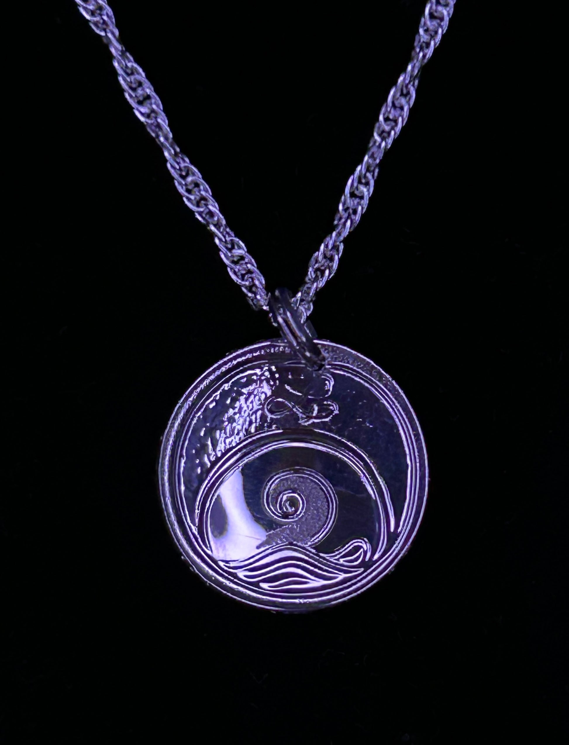 Moon Snail on the beach engraved on the back of Starfish pendant by Laura Dutheil.