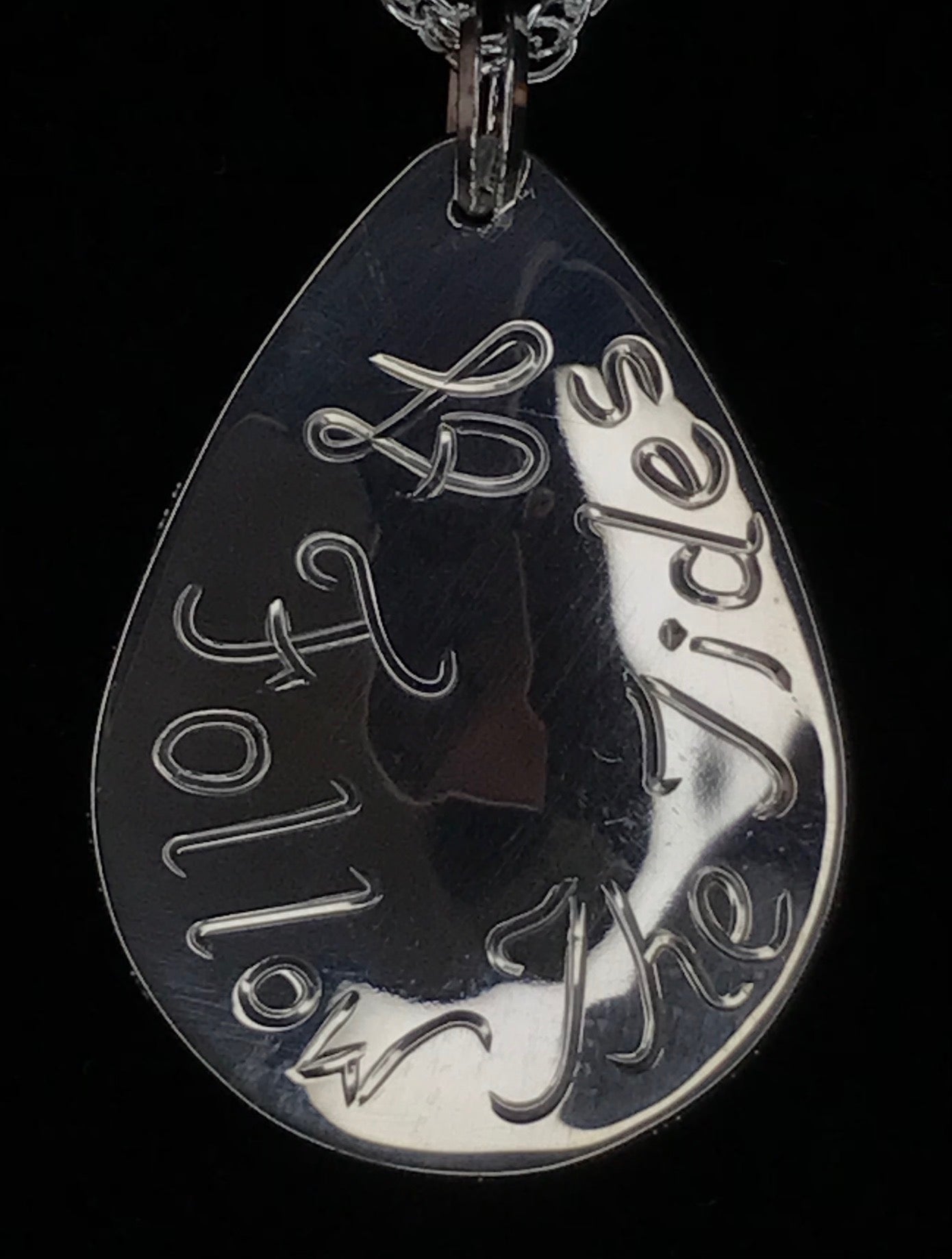 Back of Follow The Tides sterling silver pendant designed and engraved by island artisan jeweller Laura Dutheil.