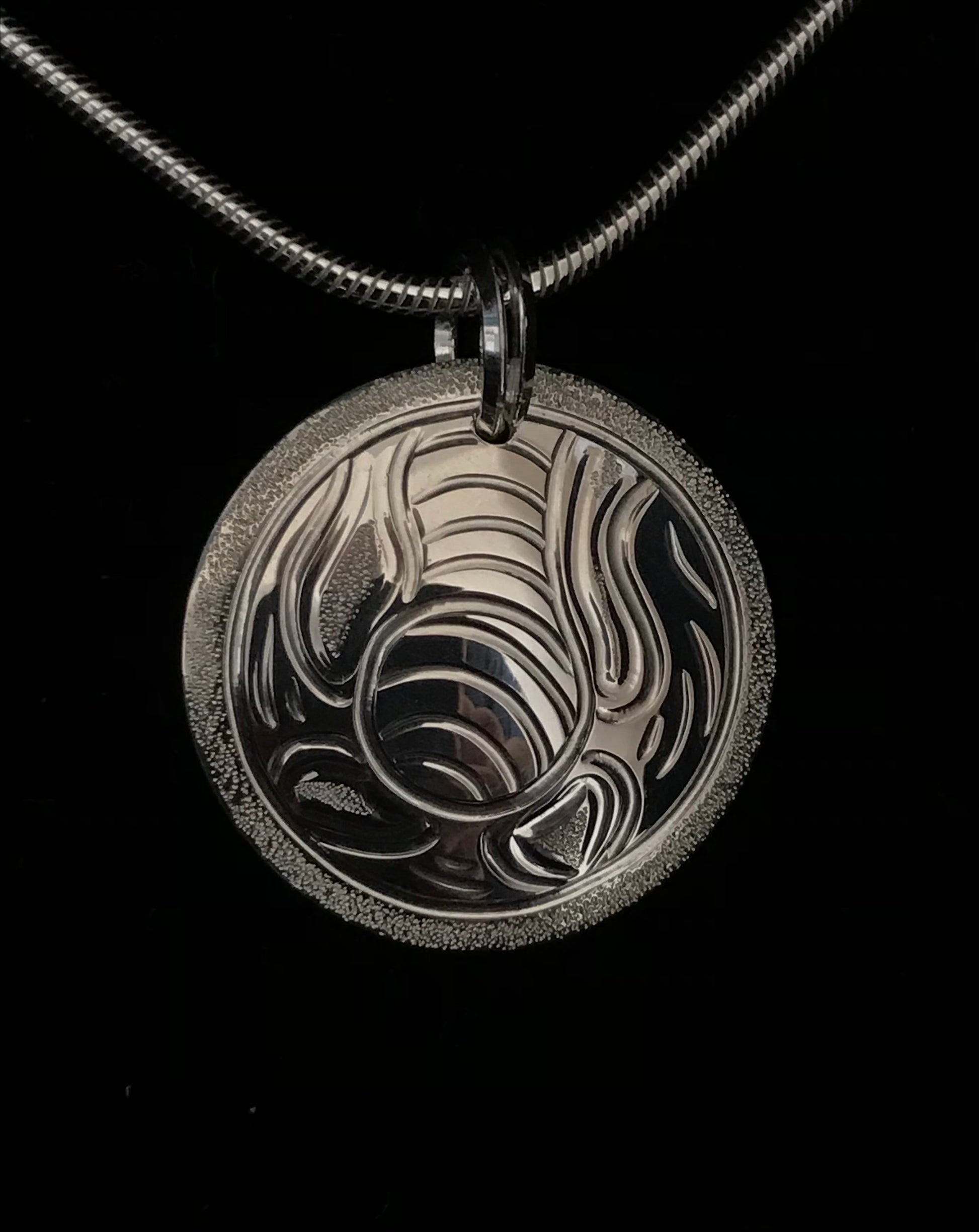 Bull Kelp sterling silver round pendant designed and engraved by island artisan jeweller Laura Dutheil.