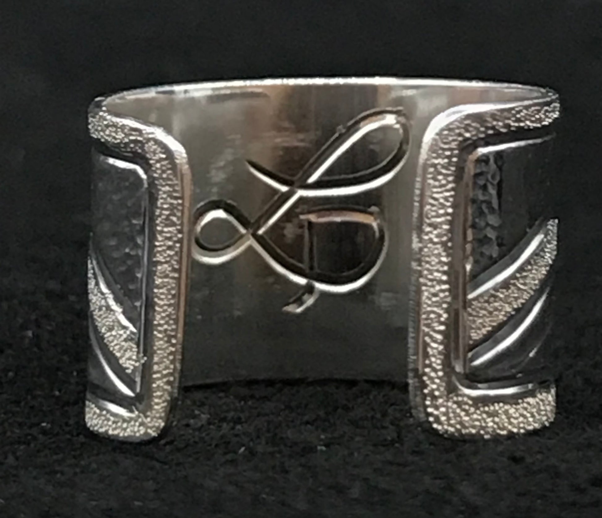 Inside of ear cuff engraved with artist's initials LD.