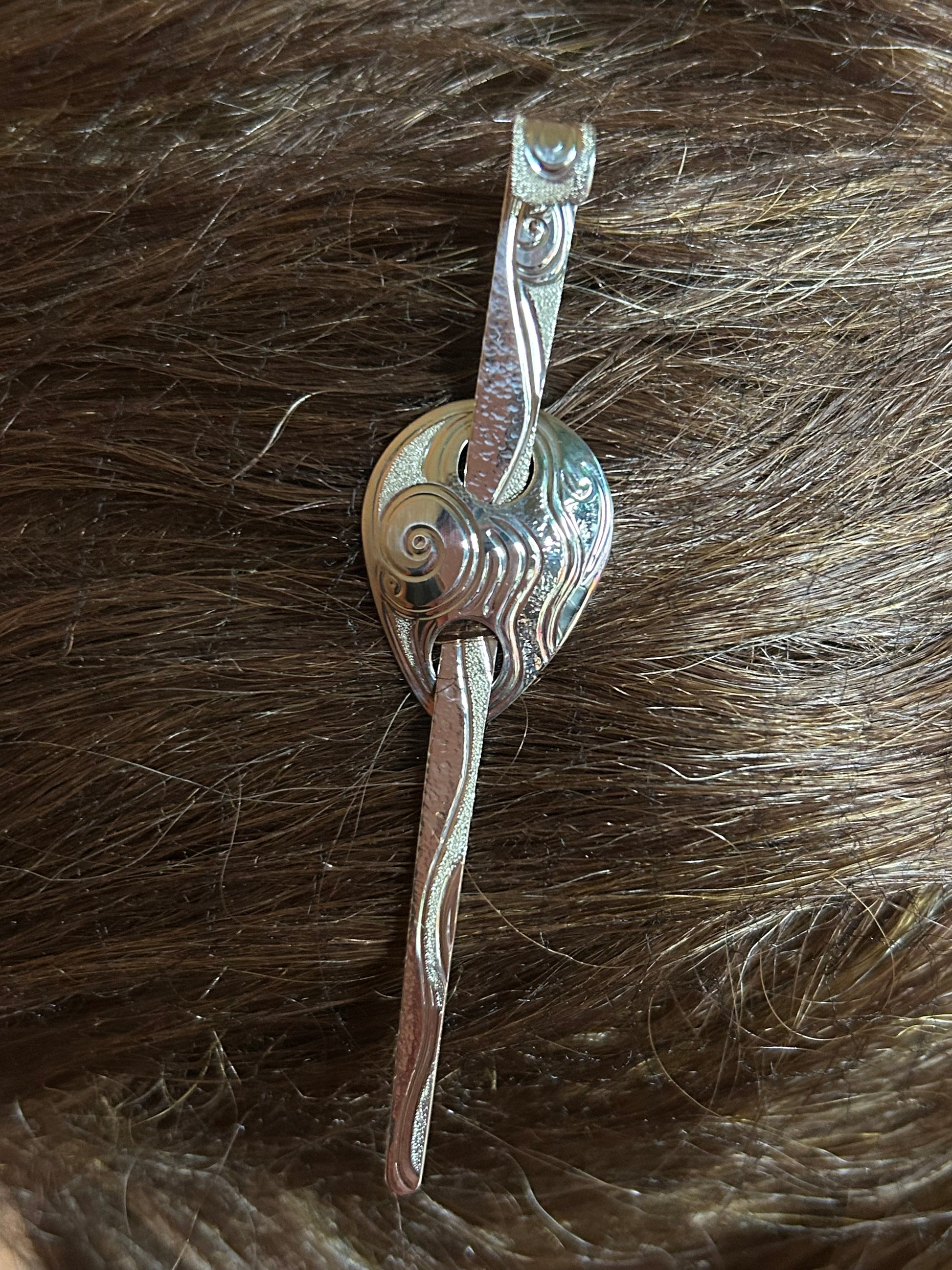 Moon Snail sterling silver hair jewellery shown on hair model.
