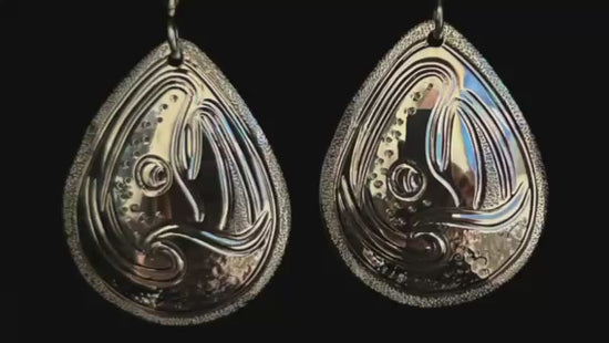 Salmon and Waves large drop sterling silver earrings designed and engraved by Island Artisan Jeweller Laura Dutheil. 