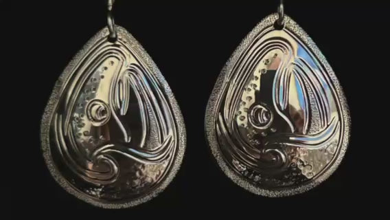 Salmon and Waves large drop sterling silver earrings designed and engraved by Island Artisan Jeweller Laura Dutheil. 