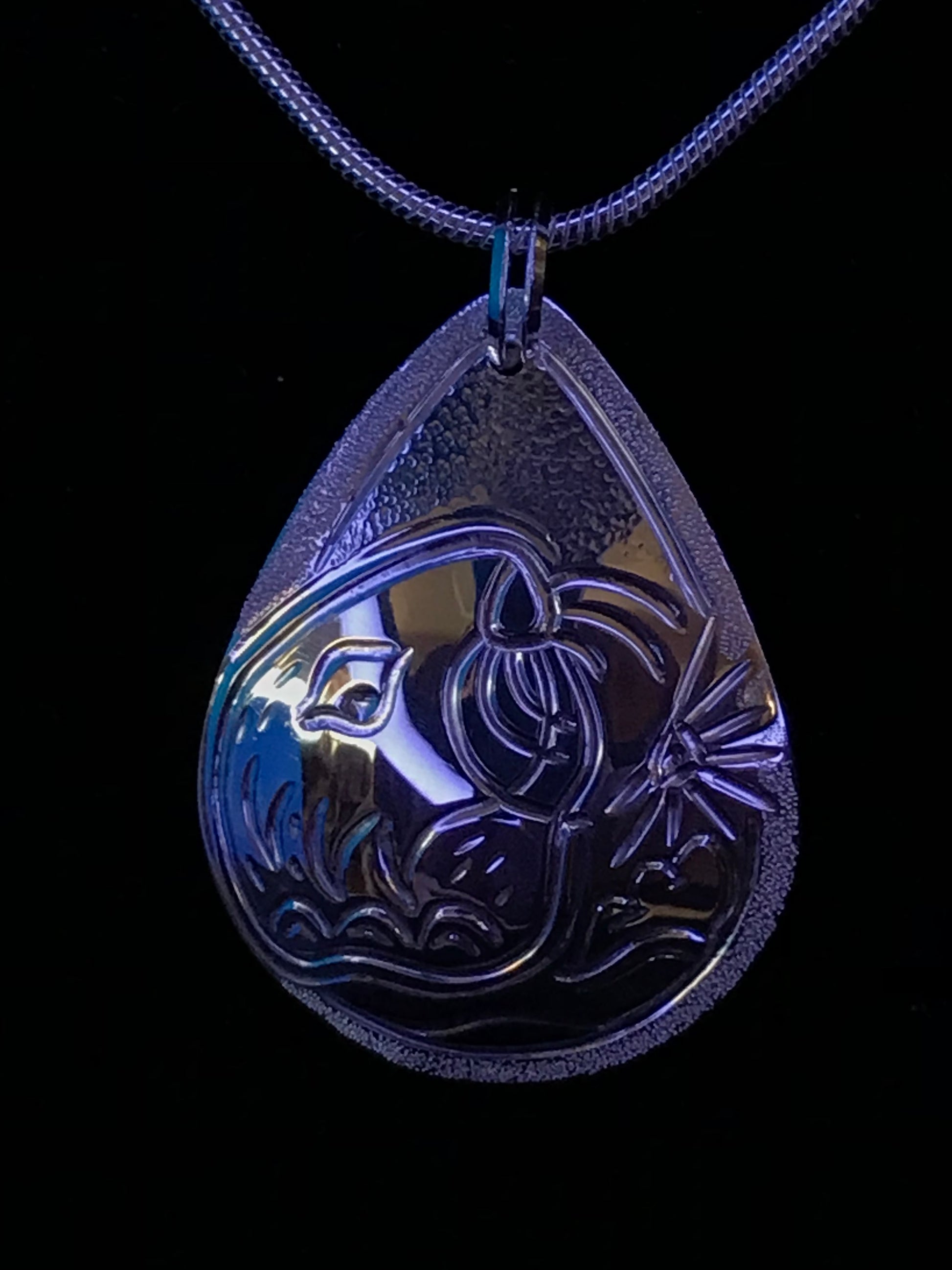 Photographed in a blue light to give ocean life effects to Sea Otter & Urchin ss drop pendant.