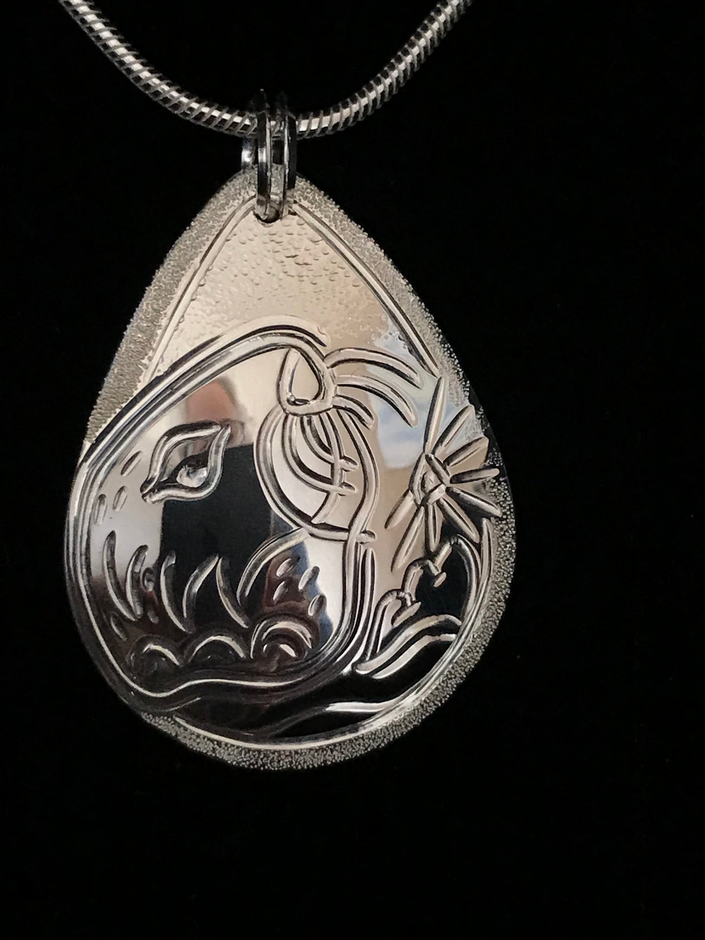 Sea Otter & Urchin sterling silver drop pendant designed and engraved by Laura Dutheil.