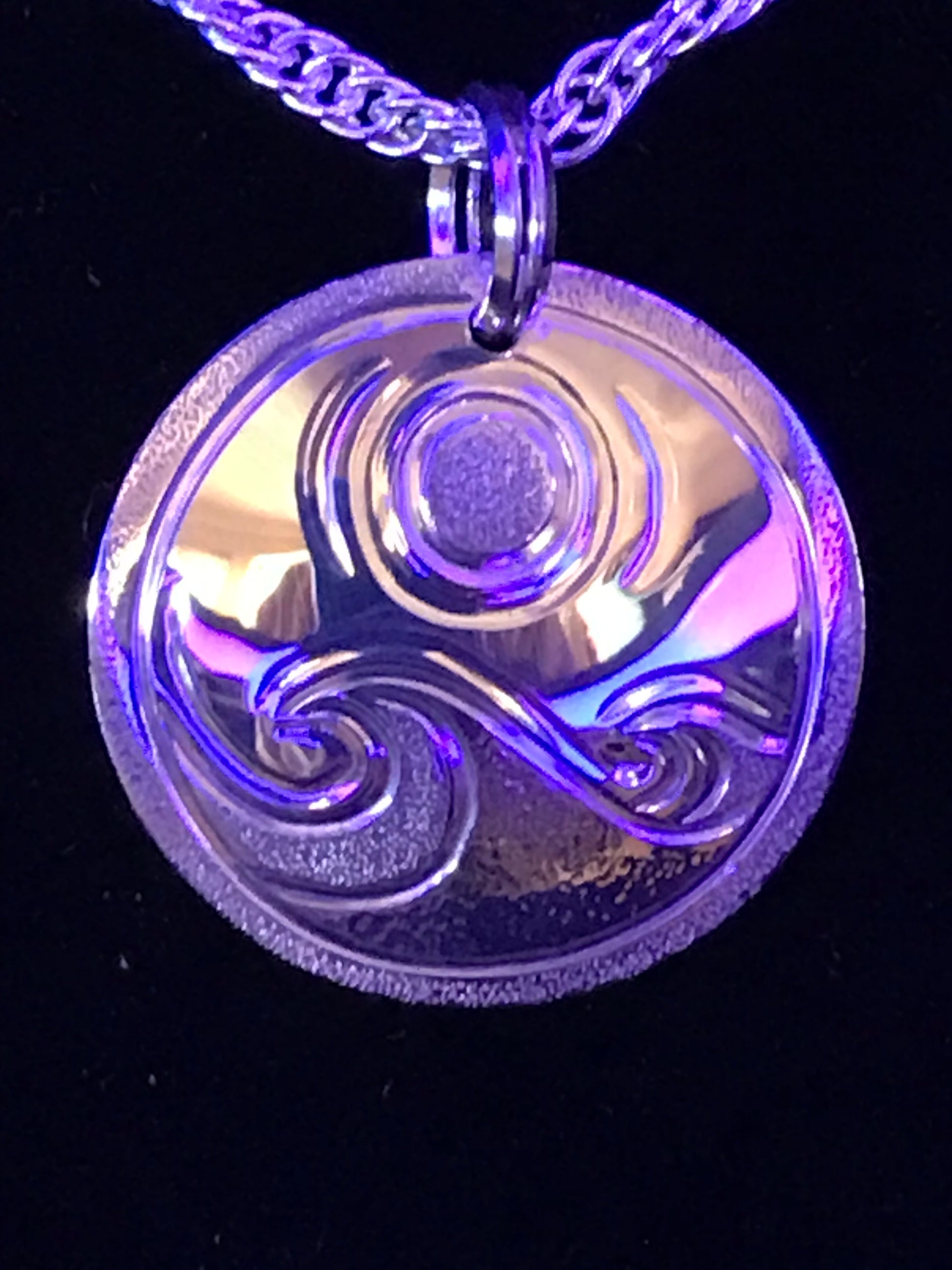 Photographed in blue light to add water effects of ocean to Waves & Full Moon pendant by Laura Dutheil.